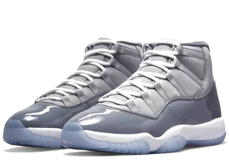 Air Jordan 11 sneakers in grey with patent leather and icy soles, showcasing iconic Jordan style.